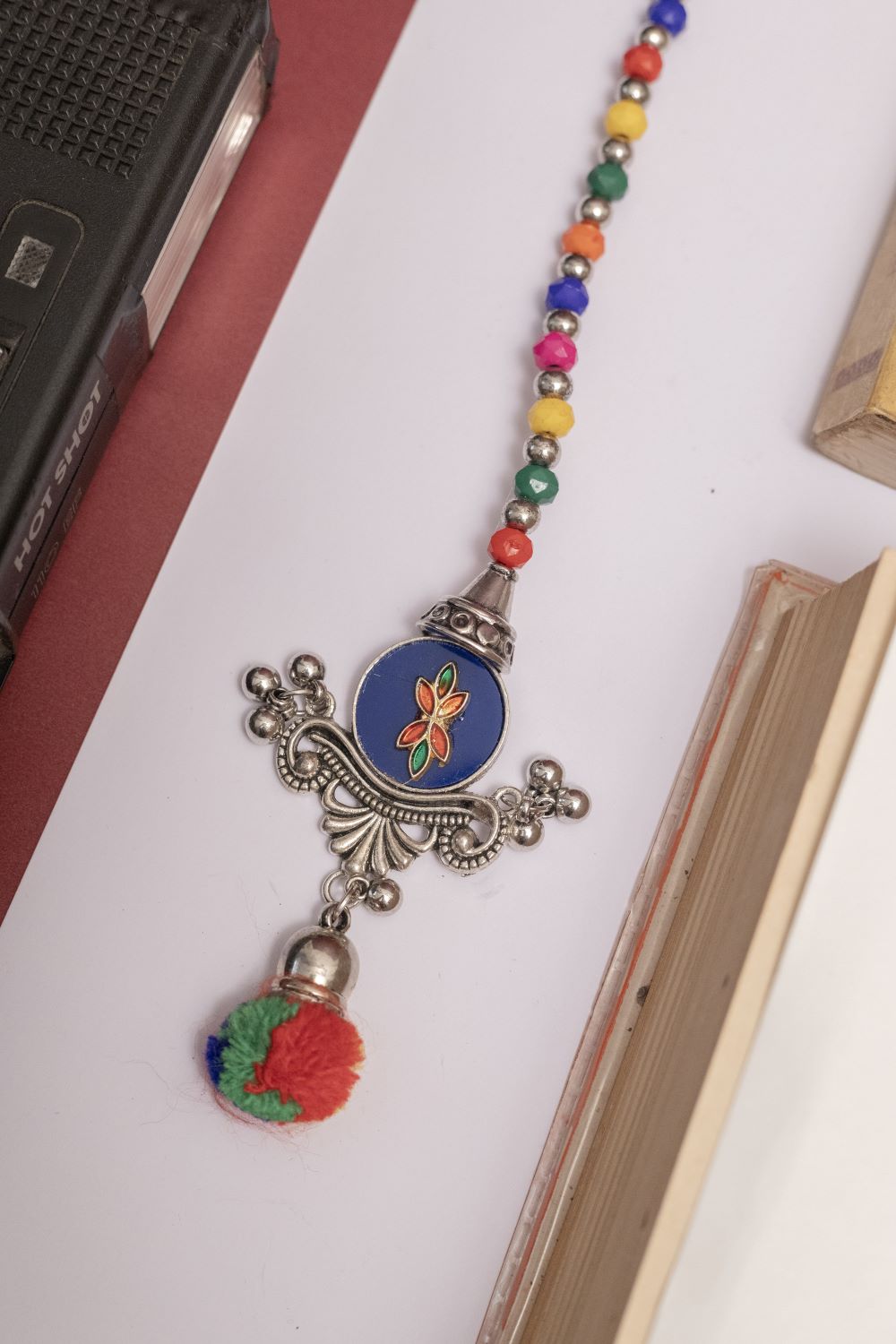 Multicolor Beaded Oxodise Tika with Red Floral Center & Pom Pom