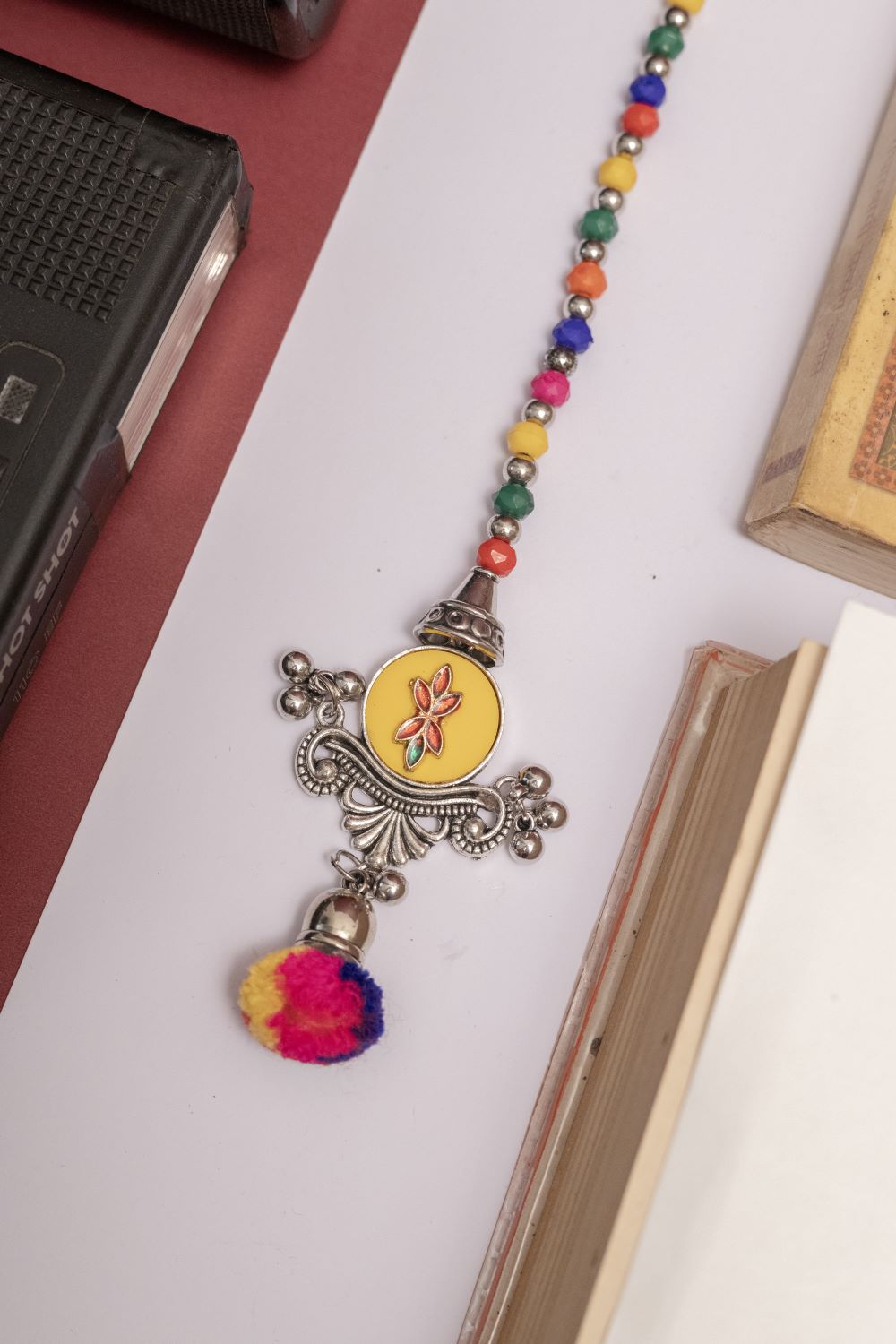 Multicolor Beaded Oxodise Tika with Red Floral Center & Pom Pom
