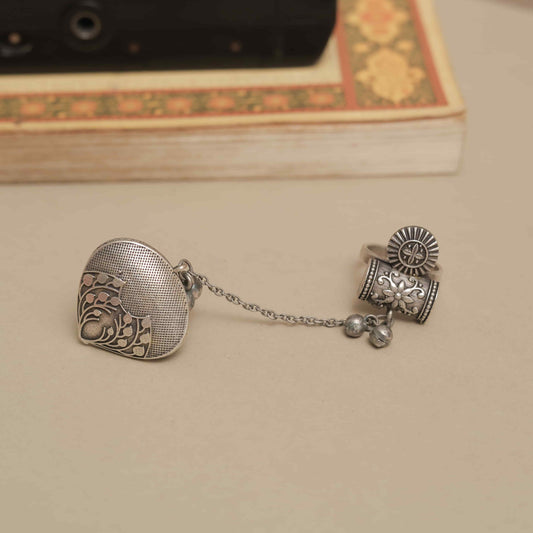 Silver Look-ALike Dual-Finger Ring with Dangling Chain and Ornate Charm